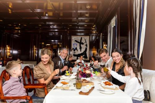 a group of people sitting around a table eating at Excelsior Hotel Ernst am Dom in Cologne