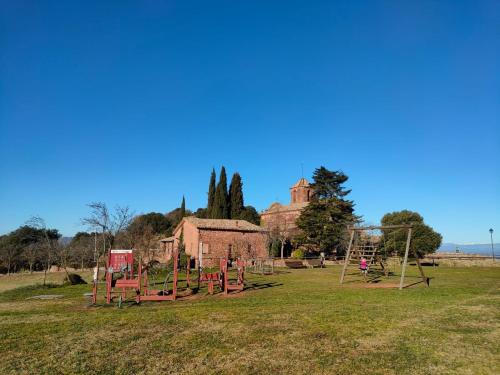 an empty park with a playground in a field at Alojamiento MAS EL CASTELL DEL BRULL in El Brull