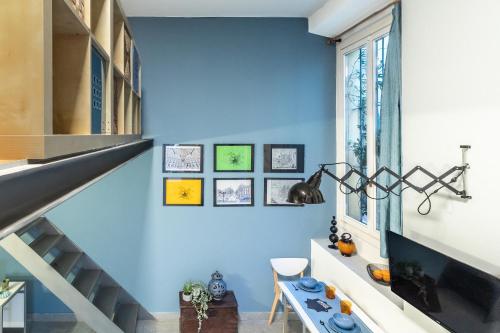 a staircase in a house with a blue wall at ALTIDO Vibrant Studio for 3 near the City Centre in Milan