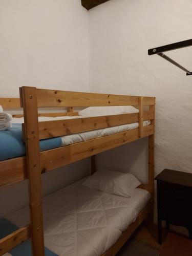 a couple of bunk beds in a room at Casa do Páteo in Vila Nova da Baronia