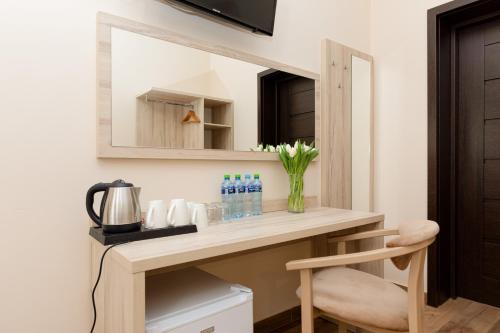 a bathroom with a vanity with a mirror at Villa Nadzieja in Międzyzdroje