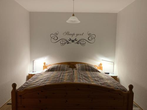 a bedroom with a bed with a sign that reads thank you at Haus Deichblick in Husum