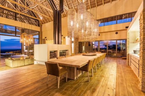 a dining room with a large wooden table and chairs at TimBila Private Villa in Omaruru