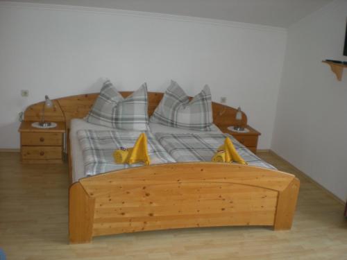 a bedroom with a wooden bed with yellow shoes on it at Landhaus - Neubauer in Schladming