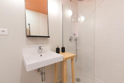 uma casa de banho branca com um lavatório e um chuveiro em Casa Rosa Villa with Pool in Olhao Centre em Olhão