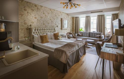 a bedroom with a large bed and a living room at Freys Hotel in Stockholm