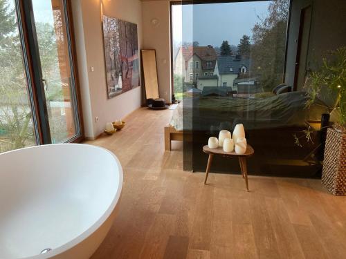 a bathroom with a tub and a large window at Poolvilla in Caputh