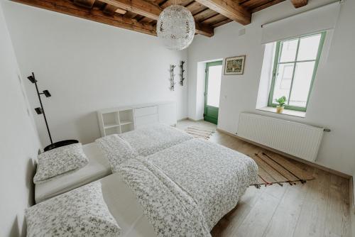 A bed or beds in a room at Casa Botár Vendégház