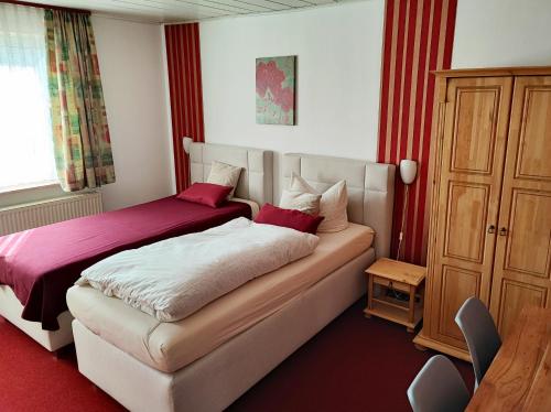 une chambre d'hôtel avec un lit et une commode dans l'établissement Hotel und Restaurant Hohenzollern, à Erfurt