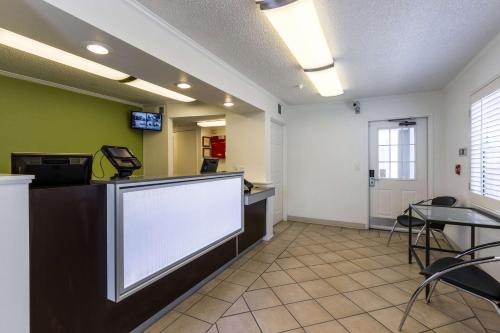 a waiting room at a hospital with a large screen at Studio 6-Tempe, AZ in Tempe