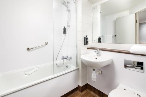 a white bathroom with a sink and a shower at ibis budget London Heathrow Central in Hounslow