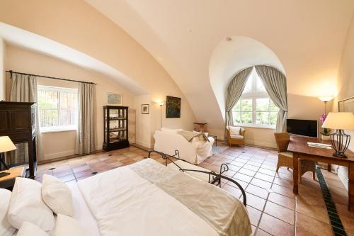 a bedroom with a bed and a living room at Wein- und Landhaus S A Prüm in Bernkastel-Kues