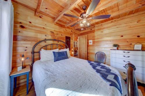 a bedroom with a bed and a ceiling fan at Log Cabin with Mountain View and Privacy in Blue Ridge