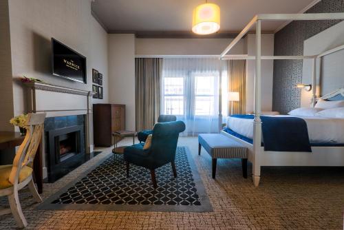 a hotel room with a bed and a fireplace at Warwick San Francisco in San Francisco