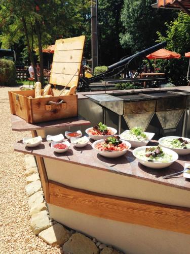 a buffet with bowls of food on a table at Hotel zur Kanone in Tautenhain