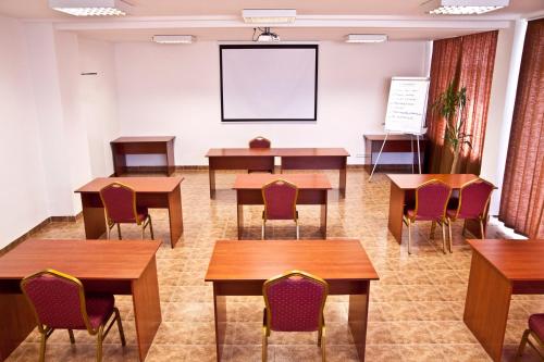 a classroom with tables and chairs and a whiteboard at Canada Hotel Budapest in Budapest