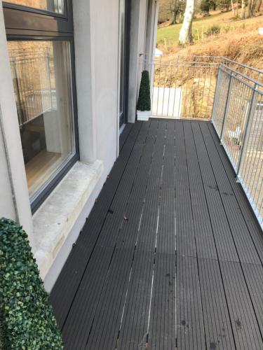 a porch with black decking on a house at Luxurious Studio Apartment in Fahan Co Donegal in Fahan