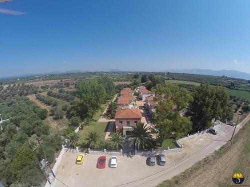 an aerial view of a house with trees and a road at Hotel Sias Resort in Agios Avgoustinos