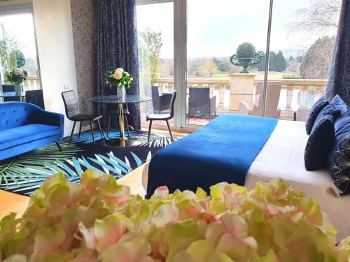 a hotel room with a bed and a large window at La Côte Saint Jacques in Joigny