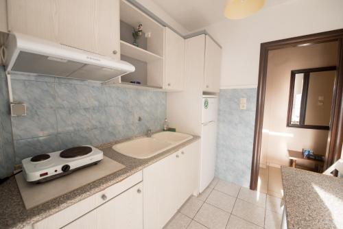 a kitchen with a sink and a counter top at Aris in Paralia Katerinis