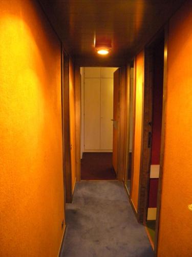 a hallway with orange walls and a white door at Natura, Sport, Relax in Pescasseroli Residence ERICA in Pescasseroli