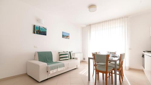 a living room with a white couch and a table at Residenza Excelsior in Vasto