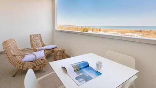 a living room with a table and chairs and a window at Residenza Excelsior in Vasto