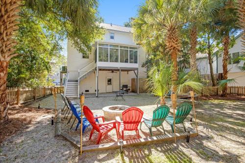a group of chairs sitting in front of a house at Anchors Away in Folly Beach
