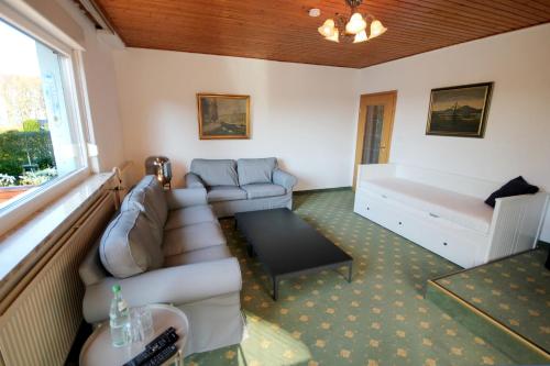 a living room with a couch and a table at Ferienhaus David Nikola in Binz