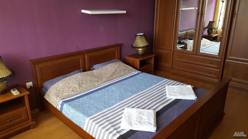 a bedroom with a bed and a mirror at Апартамент Орхид Хилс in Varna City