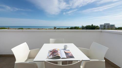 a white table and chairs on a balcony with a view at Residenza Excelsior in Vasto