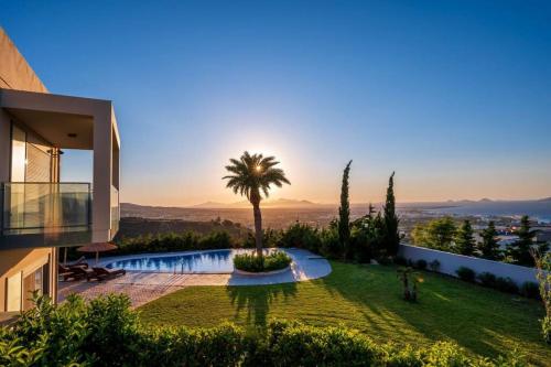 a villa with a palm tree on a hill at Breathtaking view guesthouse2 in Psalidi