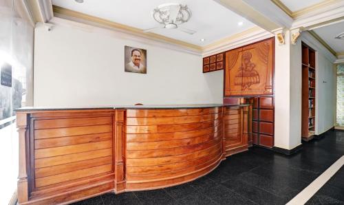 a wooden bar in a room with a wall at Itsy Hotels The Waters Edge Beach Resort in Kovalam