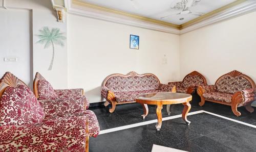 a living room with couches and a table at Itsy Hotels The Waters Edge Beach Resort in Kovalam