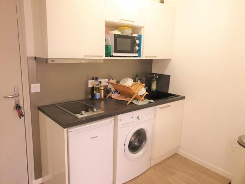 une cuisine avec un lave-linge et un micro-ondes dans l'établissement Dana centre mer 27, à Nice