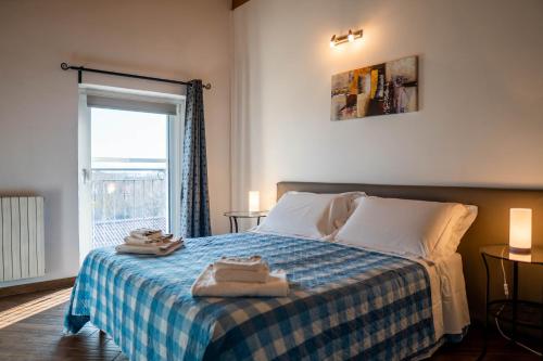 a bedroom with a bed with towels on it at Residence Le Palme in Torrazza Piemonte