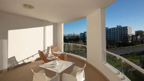 a balcony with a table and chairs on a building at Residenza Excelsior in Vasto