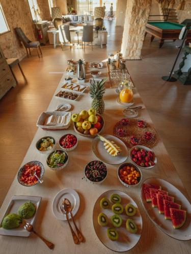 a table with many plates of food on it at Finca Gomera - Agroturismo Hotel in Cala Pi