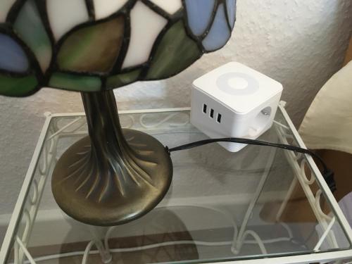 a glass vase with a clock on a glass table at Haus Silberdistel in Todtmoos