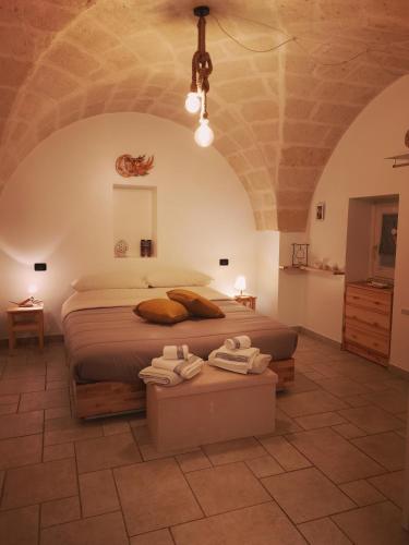 a bedroom with a bed with two towels on it at M&G Maison in Crispiano