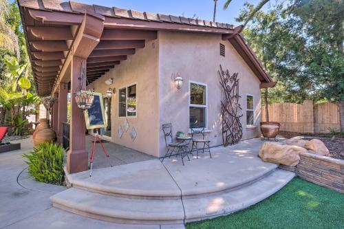 a small house with a patio with a table and chairs at Bright Poway Studio with Shared Outdoor Oasis! in Poway