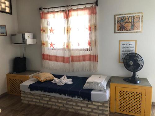 En eller flere senge i et værelse på Fiquei In Pipa - Chalé 21