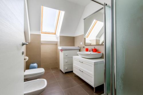 a bathroom with a toilet and a sink and a mirror at Modern APT with Terrace, WIFI & AC in Milan