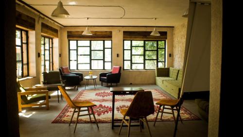 a living room with chairs and a couch and a table at Sárgarigó Élményház in Szeged