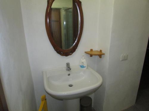 a bathroom with a sink and a mirror at La Terrazza Mombarone in Asti
