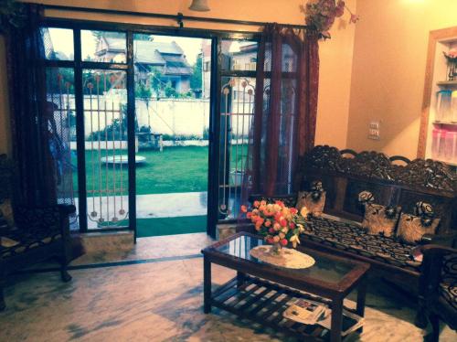 a living room with a couch and a table at Dilaram Guest House in Srinagar