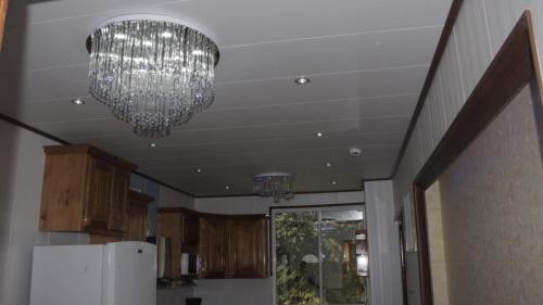 a kitchen with two chandeliers hanging from a ceiling at Riverside Hotel in Portsmouth
