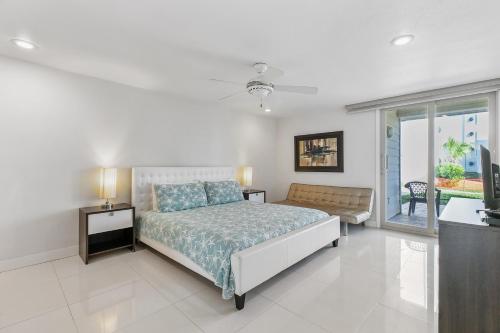 a bedroom with a bed and a large window at Ground Level Pet-Friendly Condo Seconds from Beach in South Padre Island