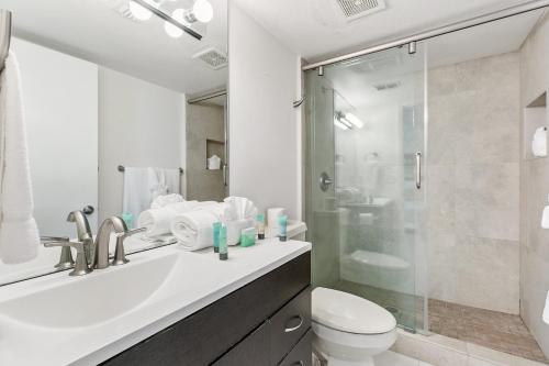 a bathroom with a sink and a toilet and a shower at Ground Level Pet-Friendly Condo Seconds from Beach in South Padre Island