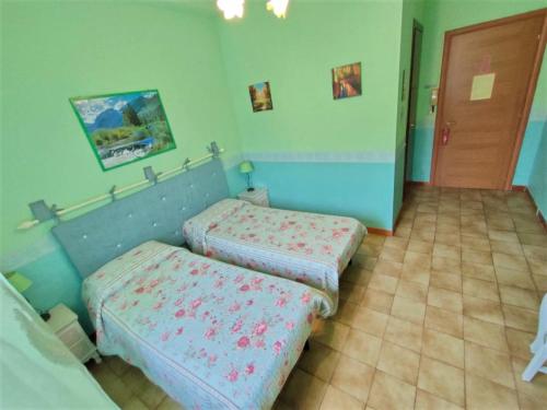 a bedroom with two beds in a room at Hotel Serenella in Turin